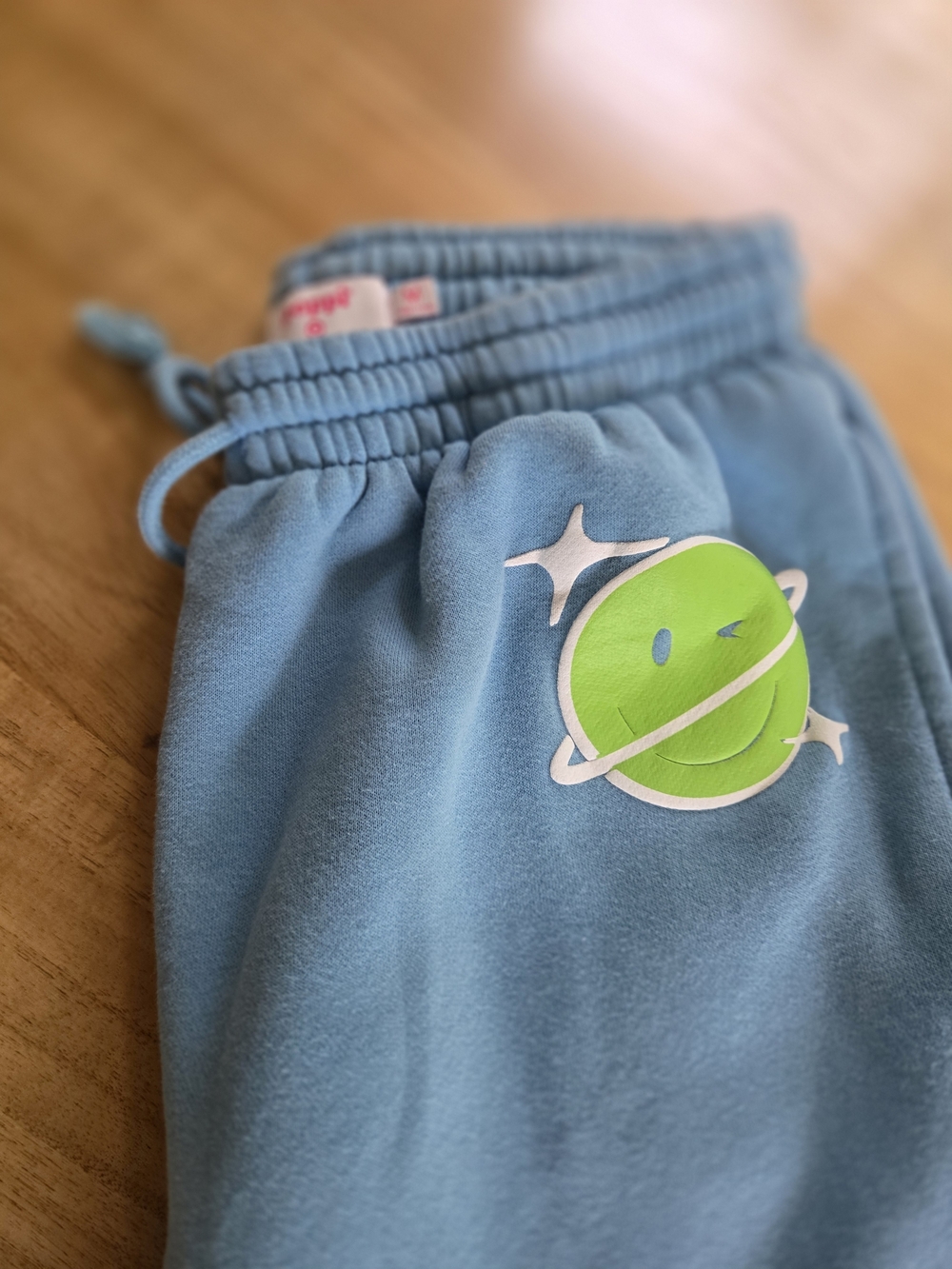 Poppi Blue Sweatpants with Green Smiley Planet Graphic